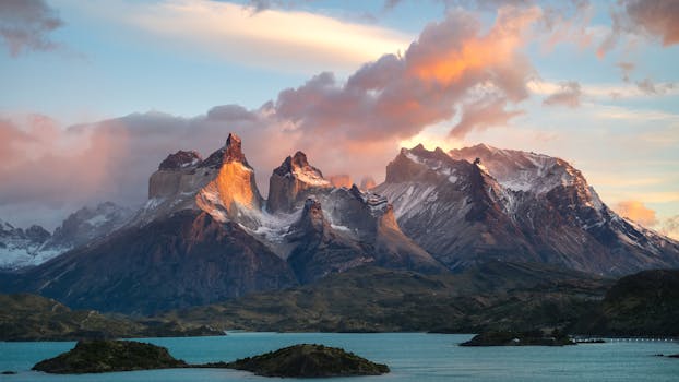 Breathtaking view of Torres del Paine at sunset with snowcapped peaks and vibrant sky.