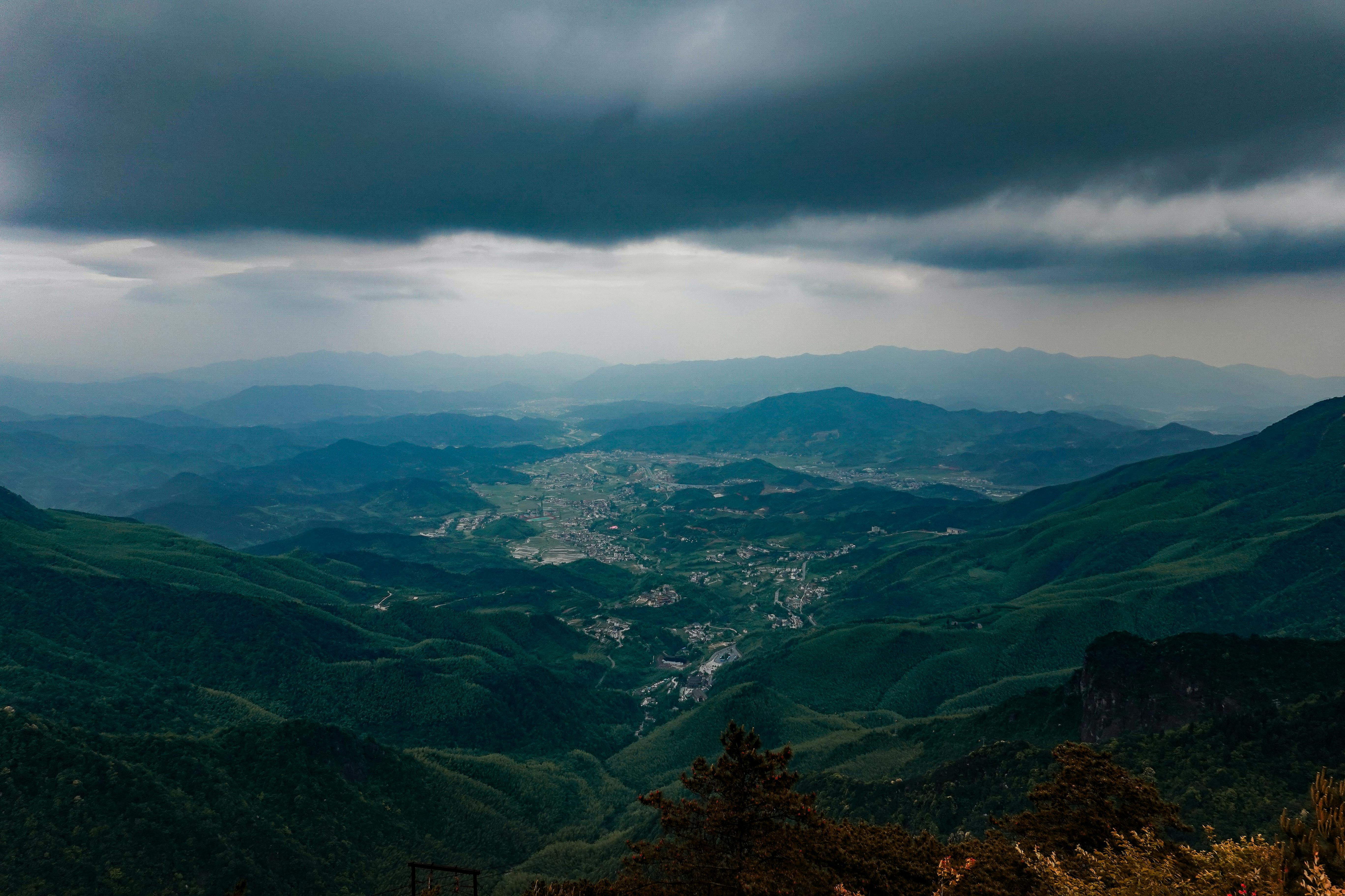 Free Scenic view of mountains and valley under dark storm clouds in Pingxiang, Jiangxi, China. Stock Photo