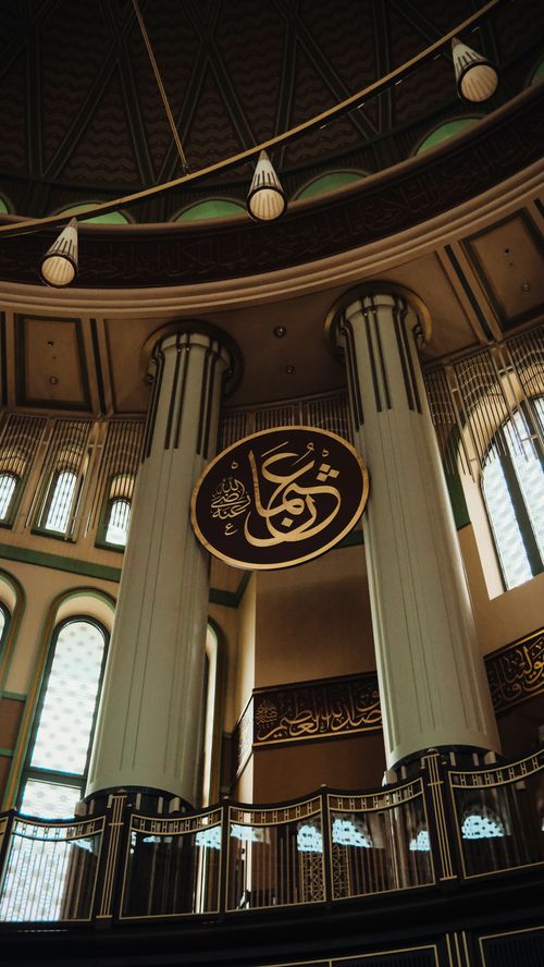 Free Ornate interior of Taksim Mosque, Istanbul, showcasing tall columns and Arabic calligraphy. Stock Photo