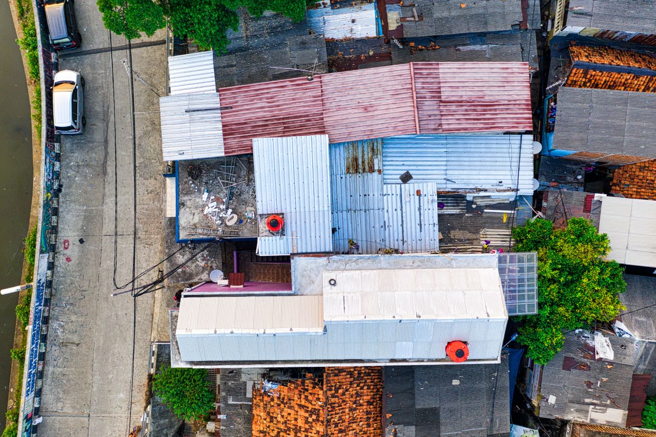 vibrant aerial shot of diverse rooftops and street in bustling urban a