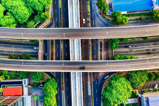 夏季多层高速公路立交桥的鸟瞰图，四周环绕着绿化