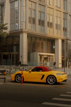 A vibrant yellow sports car parked on a modern city street.