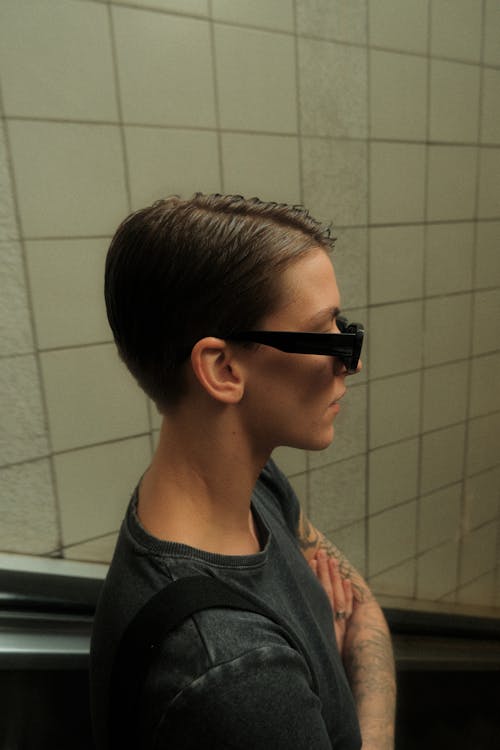 A woman with short hair wearing sunglasses