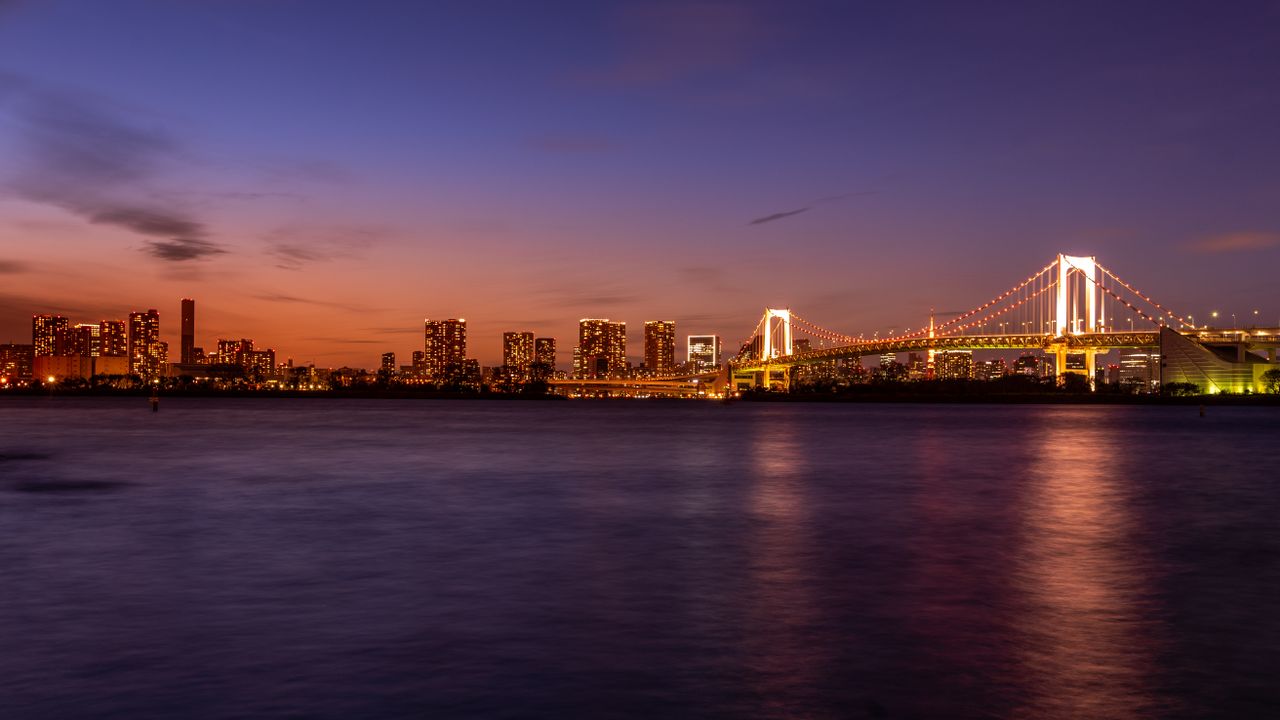 stunning evening view of tokyo skyline with illuminated rainbow bridge