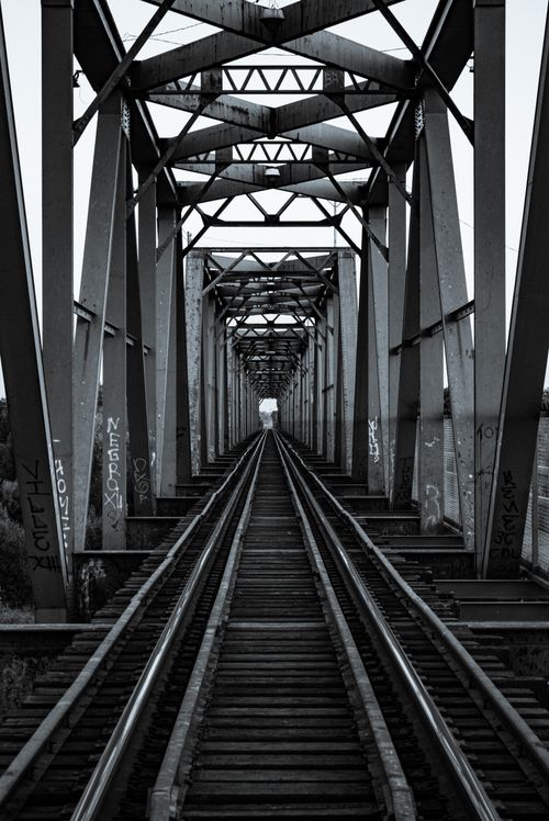 Free Black and white view of a railway bridge in Pedro Meoqui, Mexico, showcasing steel beams. Stock Photo