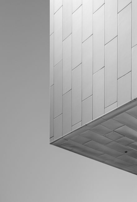 A modern, minimalist architectural structure captured in black and white, showcasing sleek design.