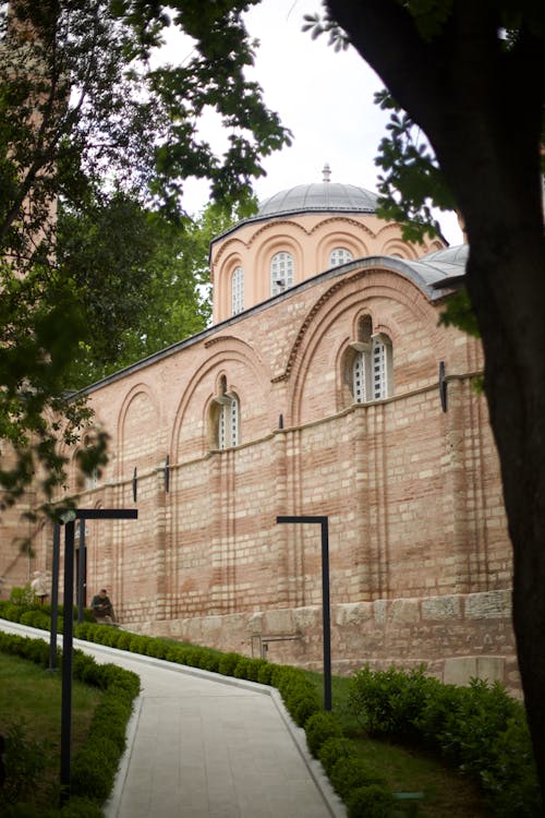 A church with a walkway and trees