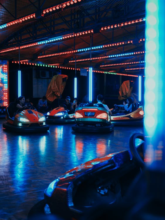 People Riding on Bump Cars