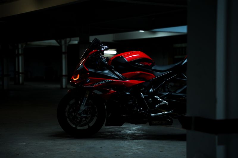A red sport motorcycle parked in a dimly lit garage