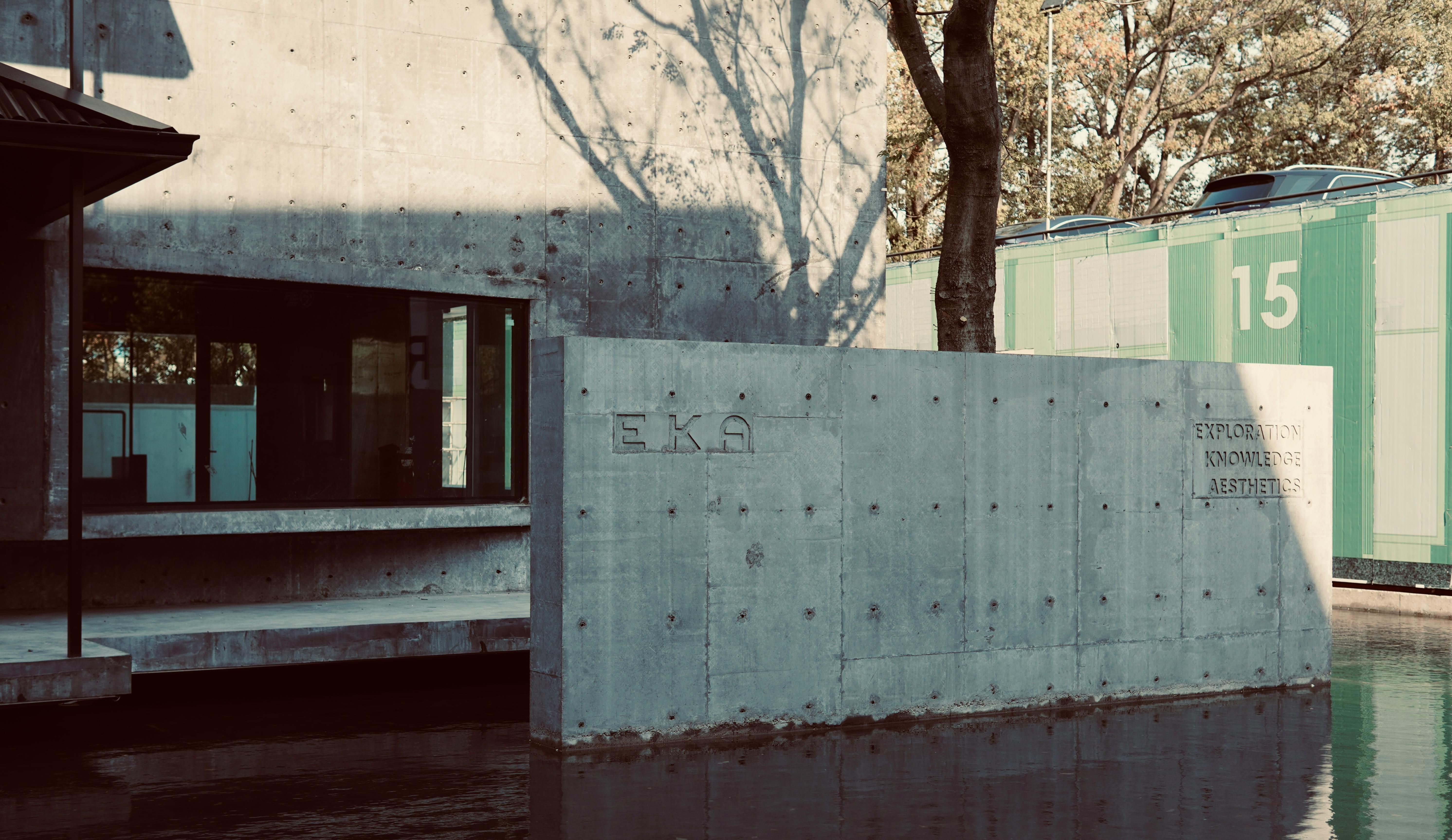 Contemporary building featuring concrete structures and a reflective water surface.