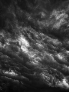 A powerful display of swirling, dramatic storm clouds in black and white, capturing nature's intensity.