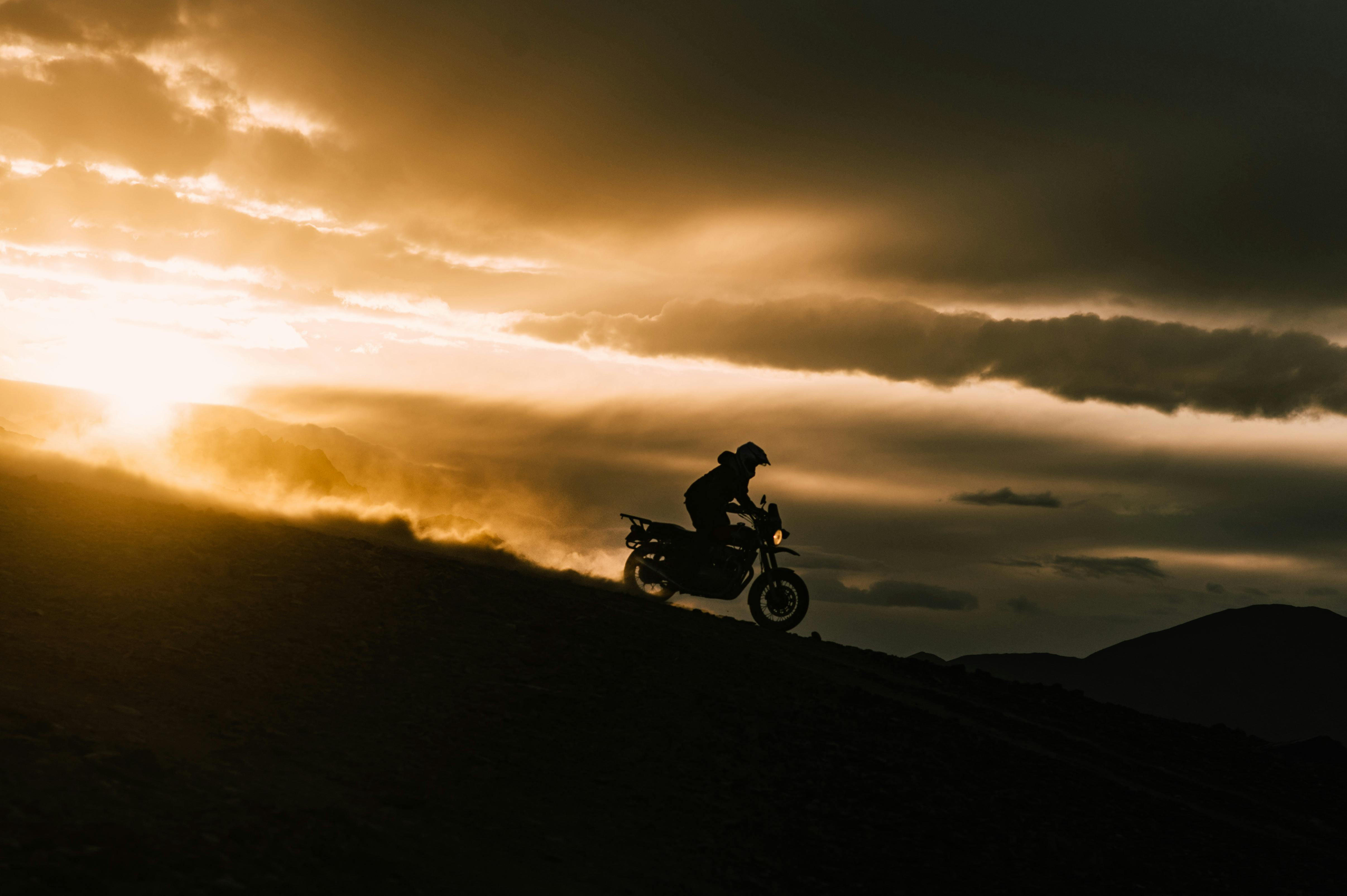 man riding motocross at sunset