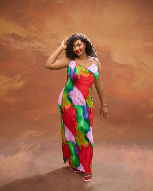 A woman in a colorful dress posing for the camera