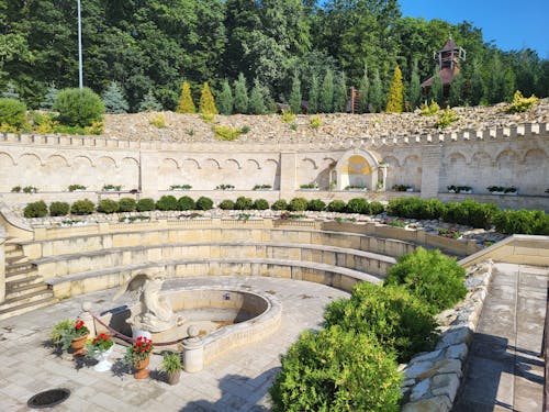 A circular stone fountain with a stone wall around it