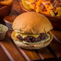 Cheeseburger on a wooden table, photo by Gezer Amorim on Pexels