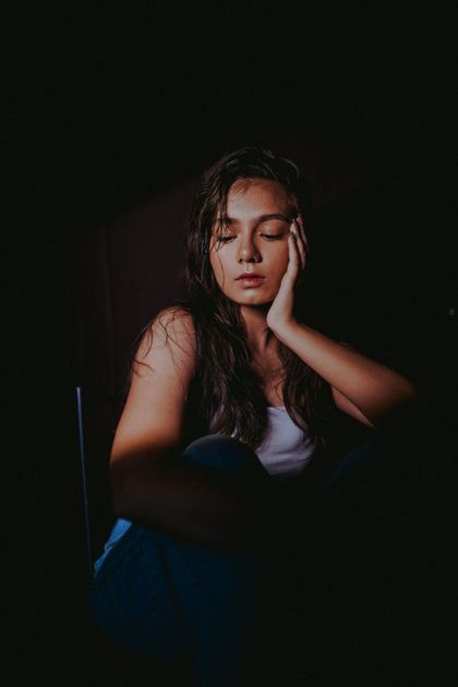 Moody portrait of a woman in low light — photo by DARKMODE CINEMA on Pexels