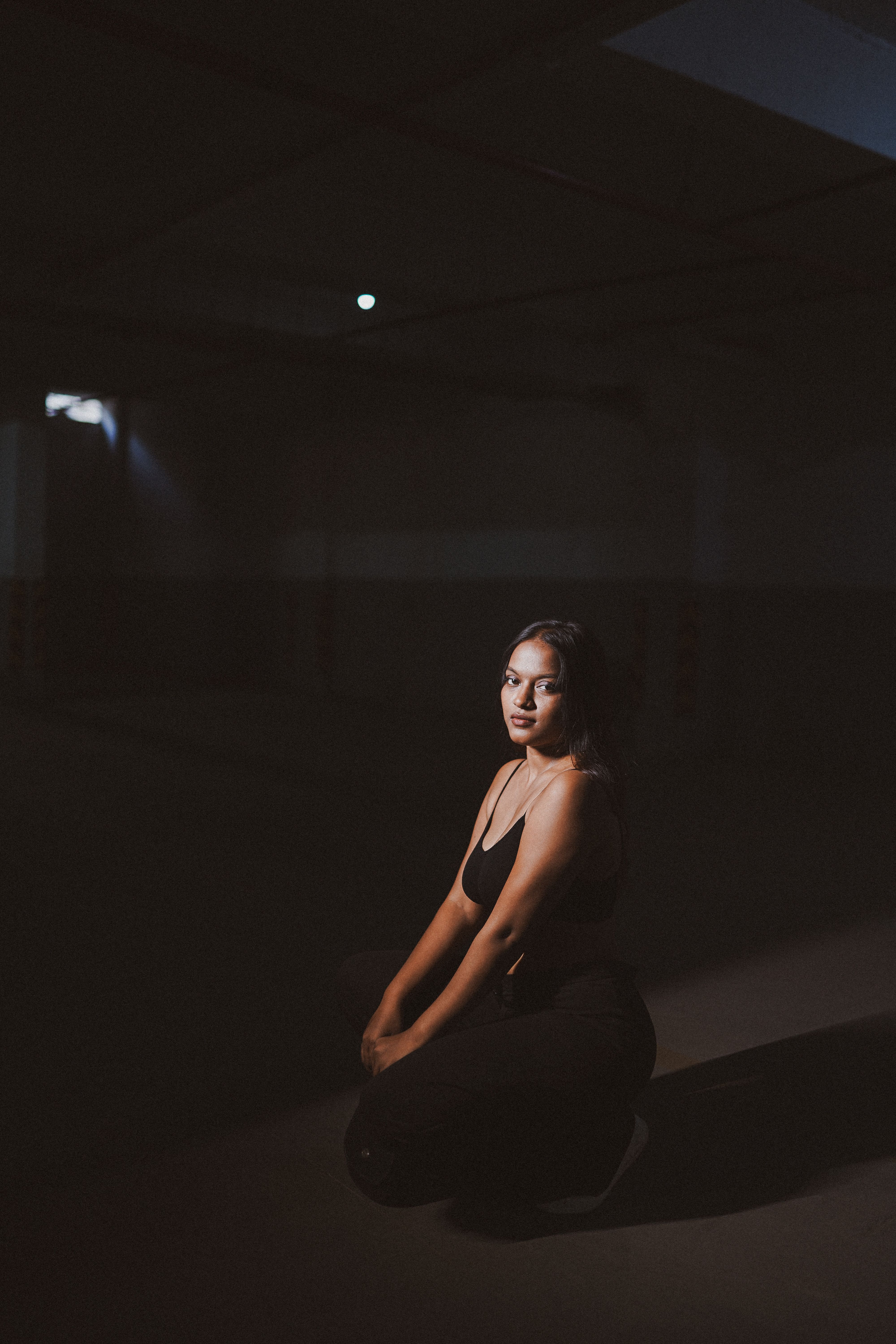 A Young Woman Posing in a Dark Room · Free Stock Photo