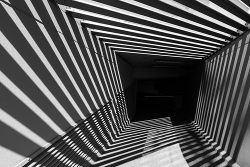 Free Striking black and white image of tunnel with geometric patterns and shadows in Hamburg. Stock Photo