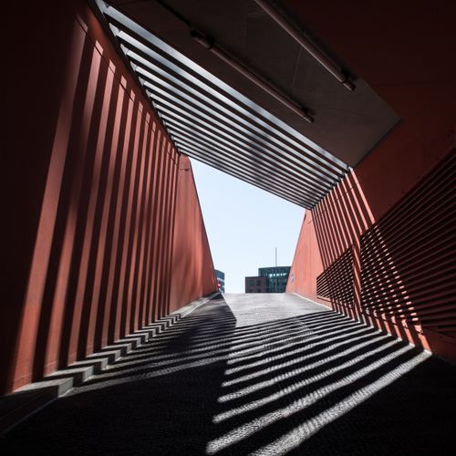 Free Modern urban architectural design in Hamburg featuring striking sunlight patterns in a walkway. Stock Photo