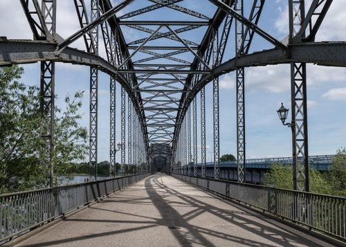 Free Iron lattice bridge Alte Harburger Elbbrücke crossing the Elbe River in Hamburg on a sunny day. Stock Photo
