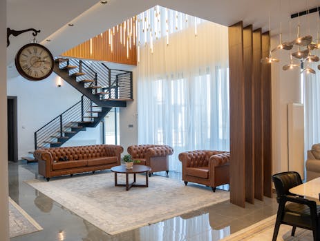 Elegant interior of a modern living room with stylish furniture and open staircase.