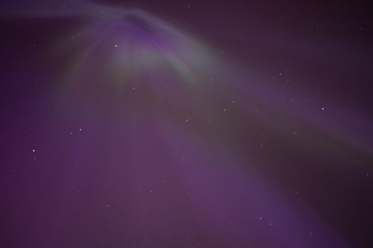 Capture of Northern Lights with purple hues in Moss, Norway's starry sky.