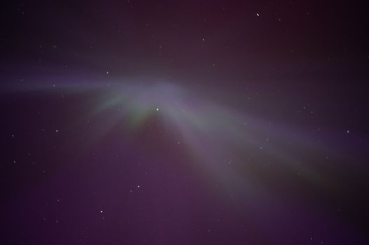 Captivating view of Aurora Borealis lighting up a starry sky in Moss, Norway.
