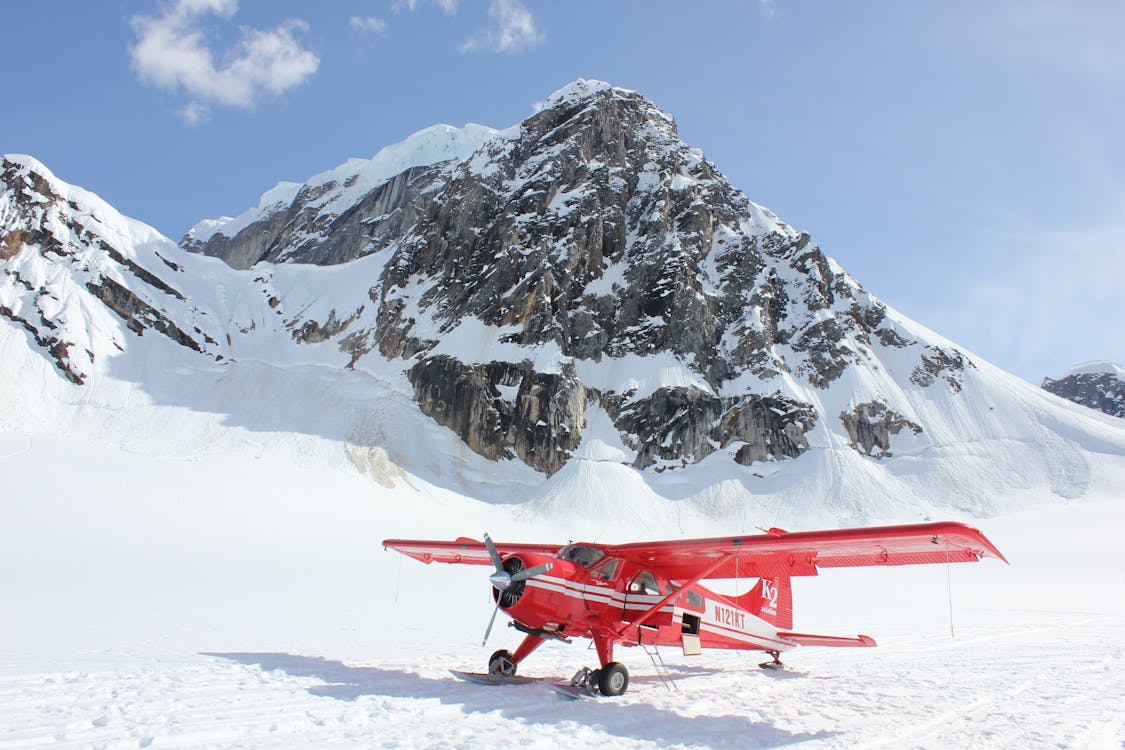 Free Red Monoplane in Alps Stock Photo