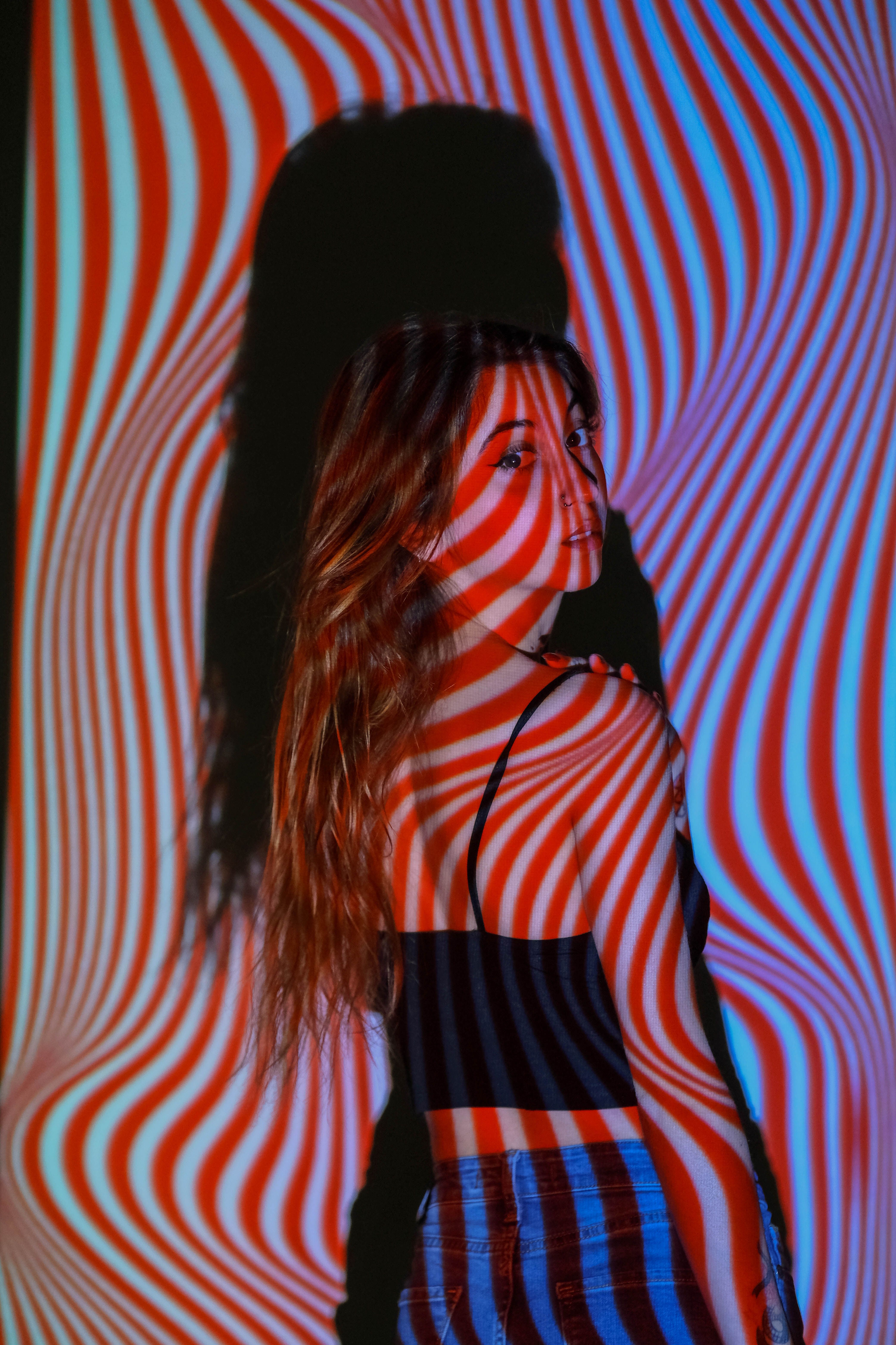 Creative portrait of a woman with vibrant light patterns in Ankara studio.