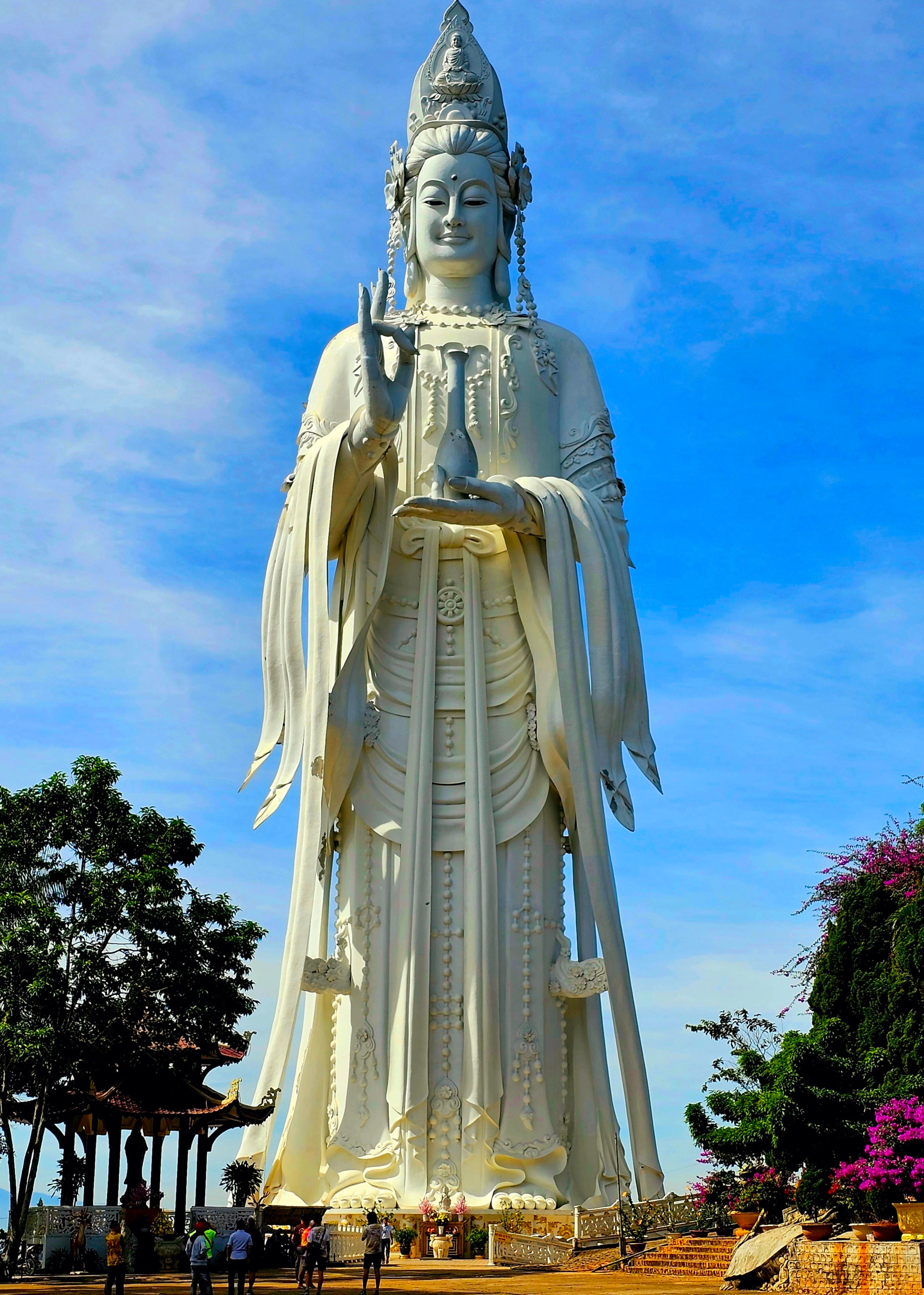 A towering statue at Linh An Pagoda against a clear blue sky in Lam Dong, Vietnam.