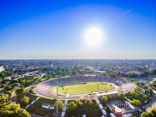 Free Panoramic aerial view of a stadium in Timișoara, Romania under a clear blue sky. Stock Photo