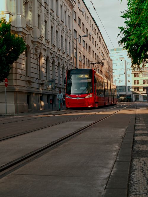 Free A red tram travels down a city street in Bratislava, Slovakia. Stock Photo