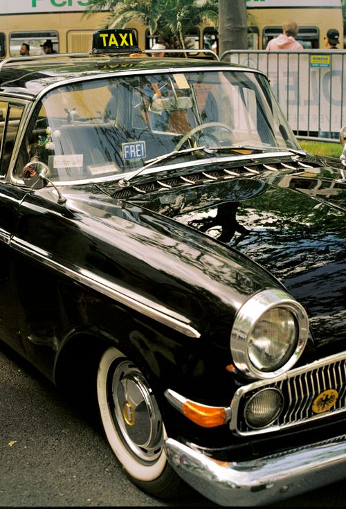 Free Vintage black taxi showcases classic charm in Berlin's vibrant streets, embodying nostalgic allure. Stock Photo