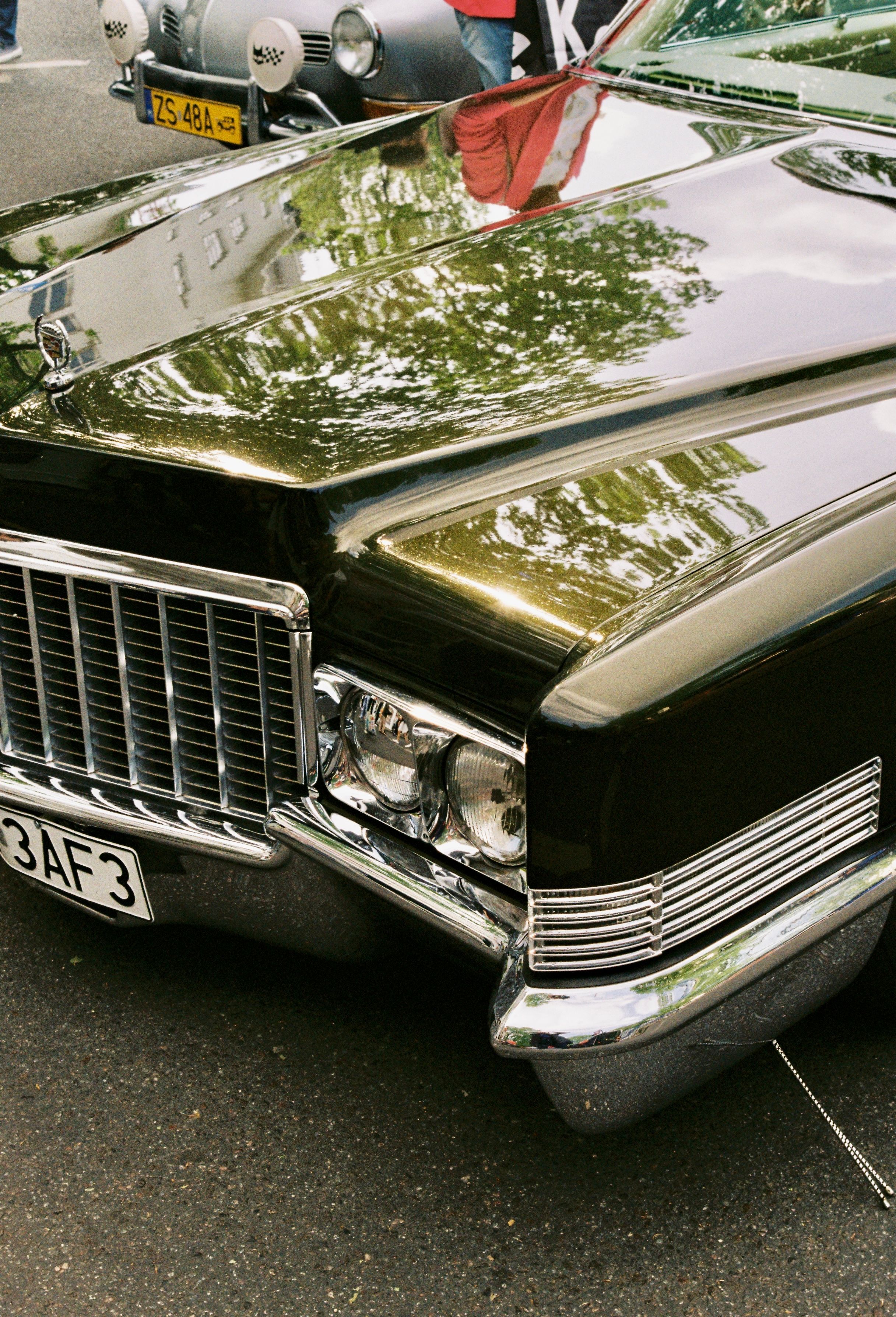 Close-up of a vintage Cadillac De Ville at a car show in Berlin, showcasing its classic design.
