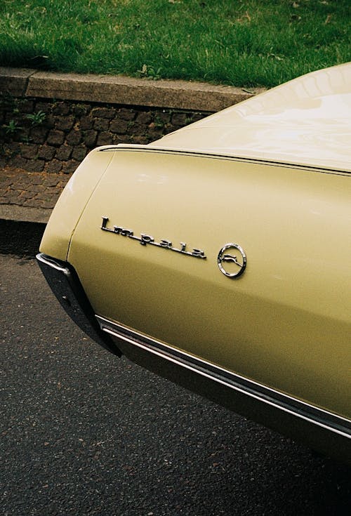 A close up of a classic car with the hood up