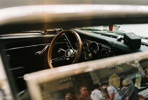 A vintage car with a steering wheel and dashboard