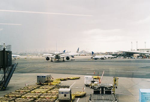 A large airport terminal with a large airplane on the tarmac