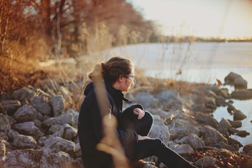 Free Woman Sitting Beside River Stock Photo