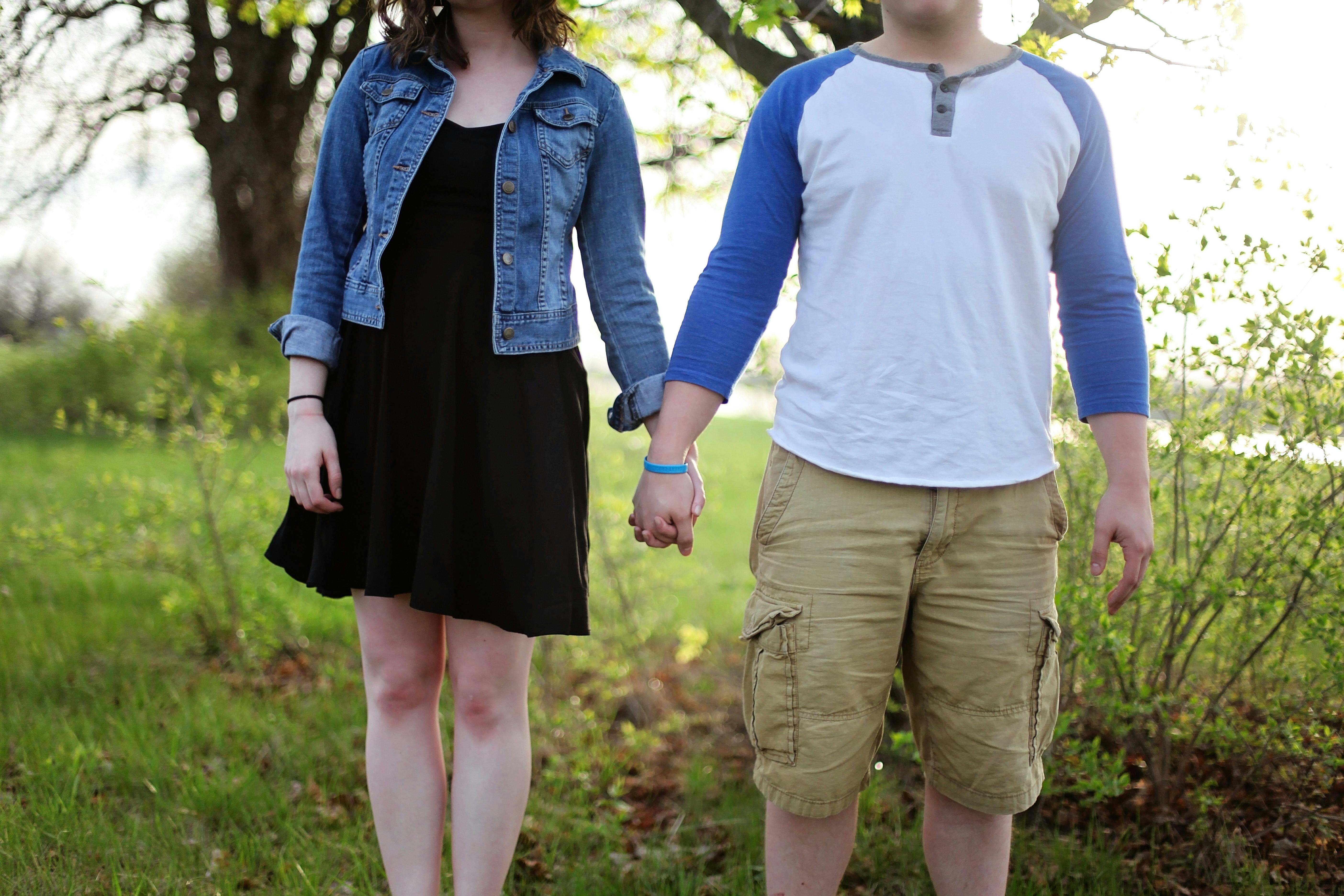 Man and Woman Holding Hands While Standing