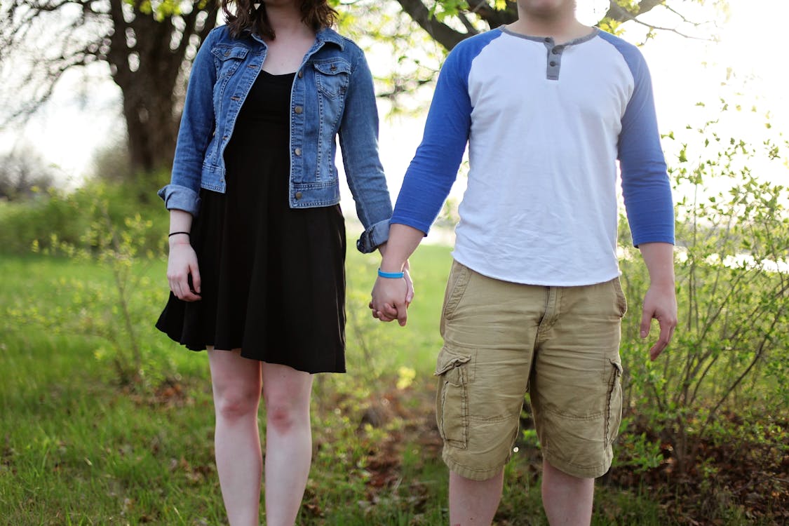 Free Man and Woman Holding Hands While Standing Stock Photo