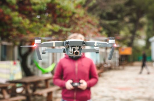 A DJI Mavic Pro drone hovers outdoors with a person controlling it in Limassol, Cyprus.