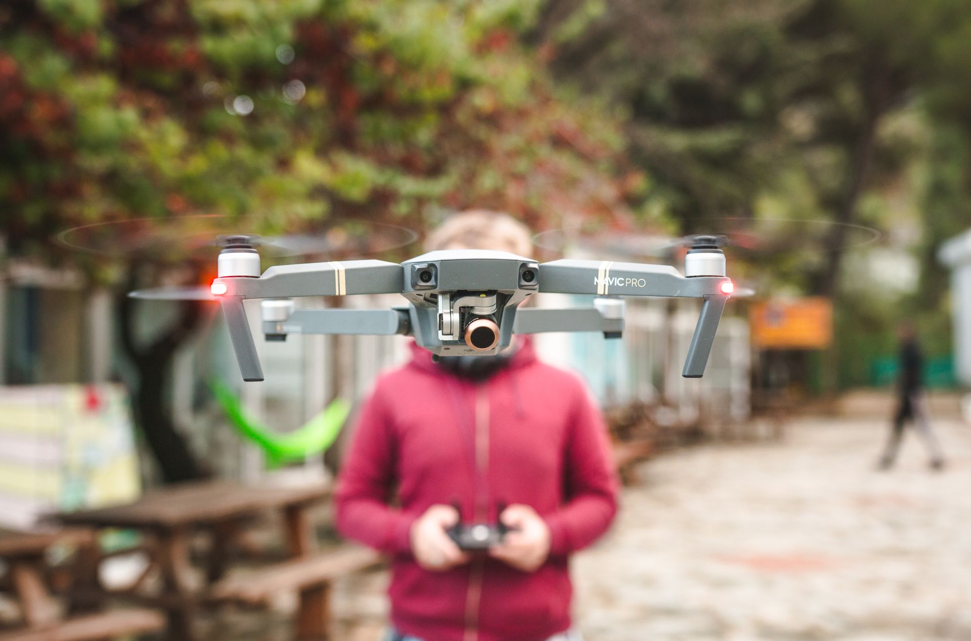 A DJI Mavic Pro drone hovers outdoors with a person controlling it in Limassol, Cyprus.