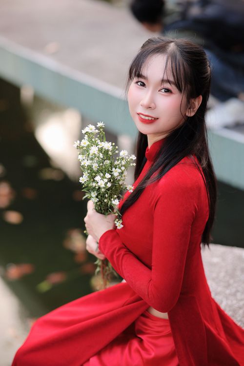 Elegant Woman in Red with Lilies Outdoors · Free Stock Photo