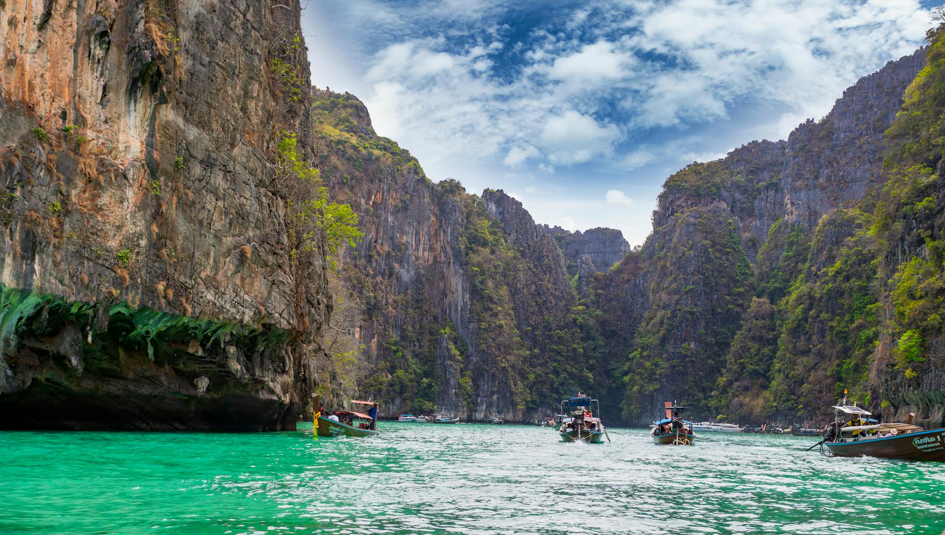 Explore the breathtaking cliffs and turquoise waters of Pi Leh Bay in Thailand, a popular travel destination.