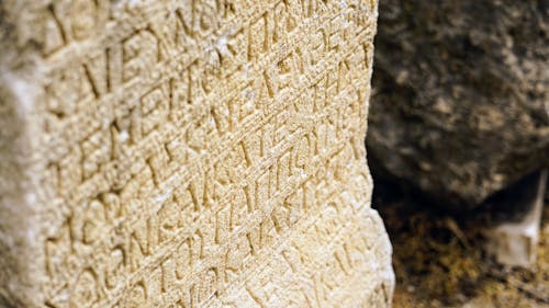 A close up of a stone with writing on it