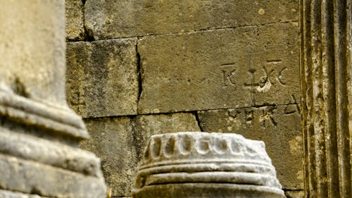 A close up of a stone pillar with writing on it