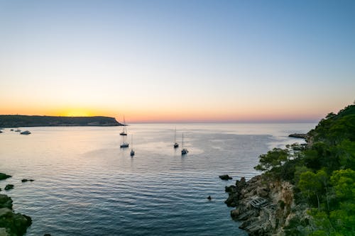 Безкоштовне стокове фото на тему «берег моря, вода, Захід сонця»