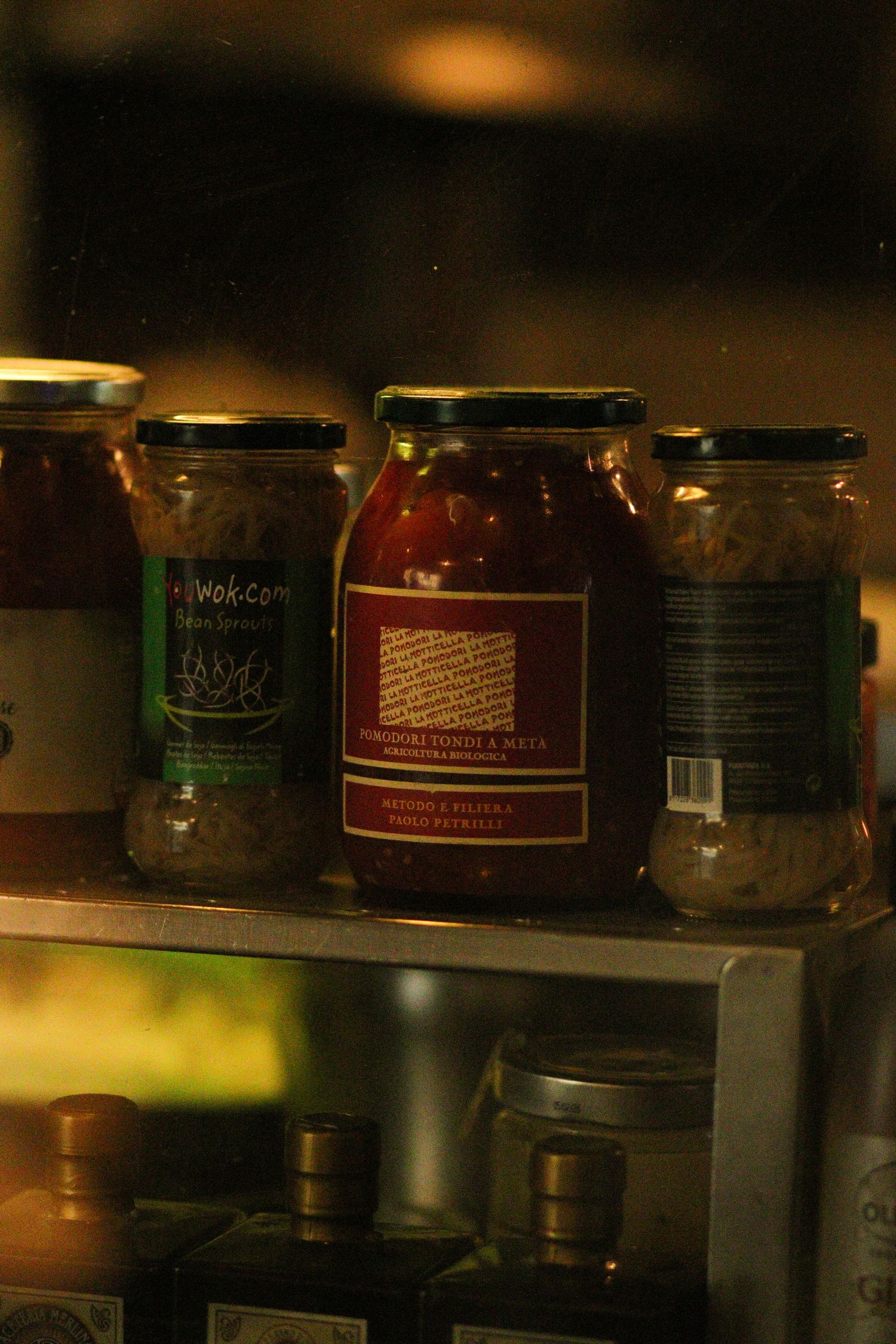Glass jars filled with food arranged on shelves.