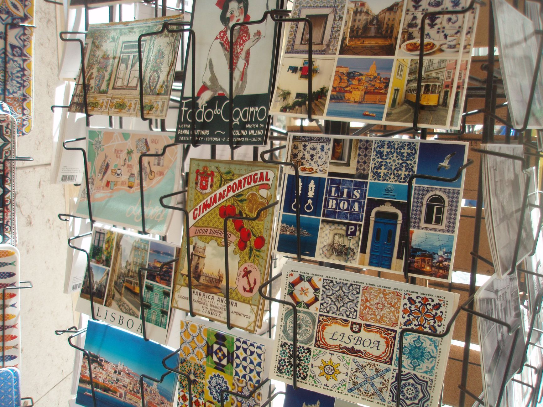 Vibrant postcards display Lisbon's famous tiles and landmarks, capturing the city's essence.