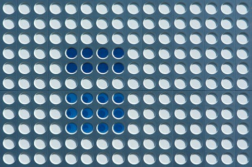 A blue and white tile with dots on it